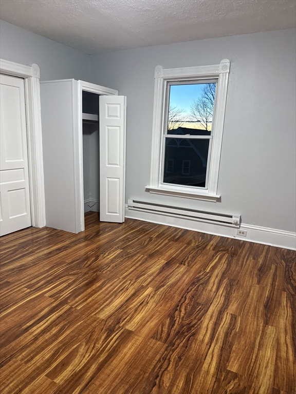 2 Orne Street, Unit 2 Worcester, MA 01605 - Photo 7 of 10 a view of an empty room with wooden floor and a window