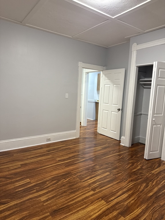 2 Orne Street, Unit 2 Worcester, MA 01605 - Photo 9 of 10 an empty room with wooden floor and refrigerator