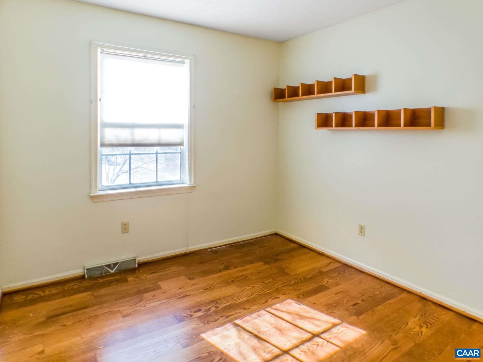 300 Westfield Road Charlottesville, VA 22901 - Photo 18 of 26 a view of an empty room with wooden floor and a window