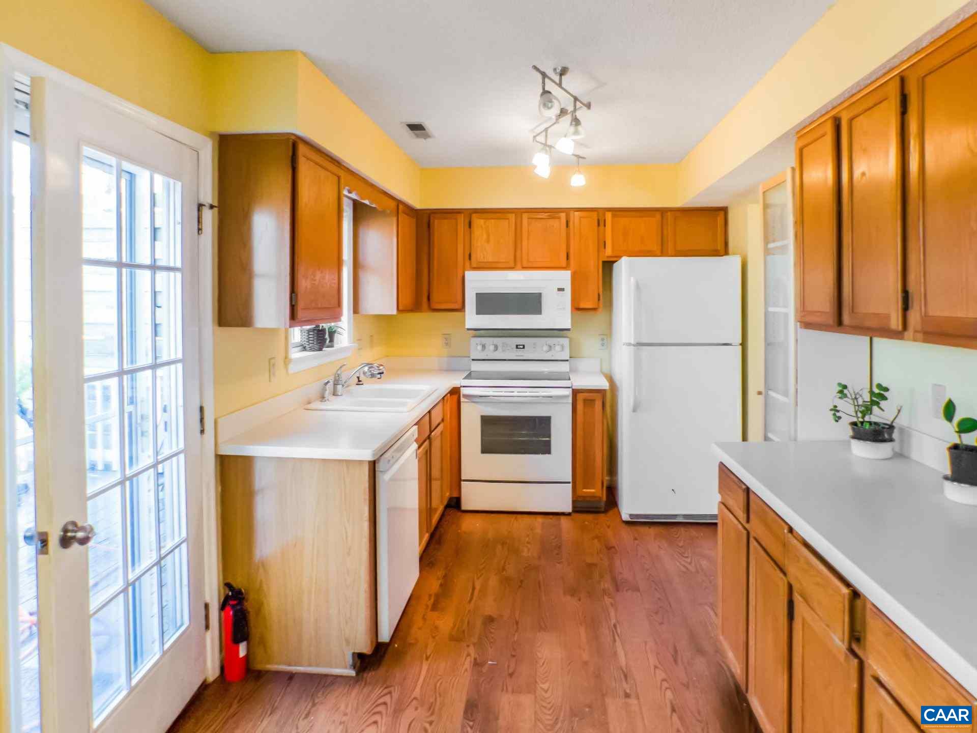 300 Westfield Road Charlottesville, VA 22901 - Photo 3 of 26 a kitchen with a refrigerator a stove top oven a sink and a large window