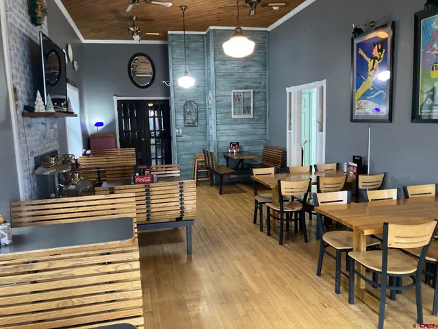 a view of a dining room with furniture kitchen and wooden floor