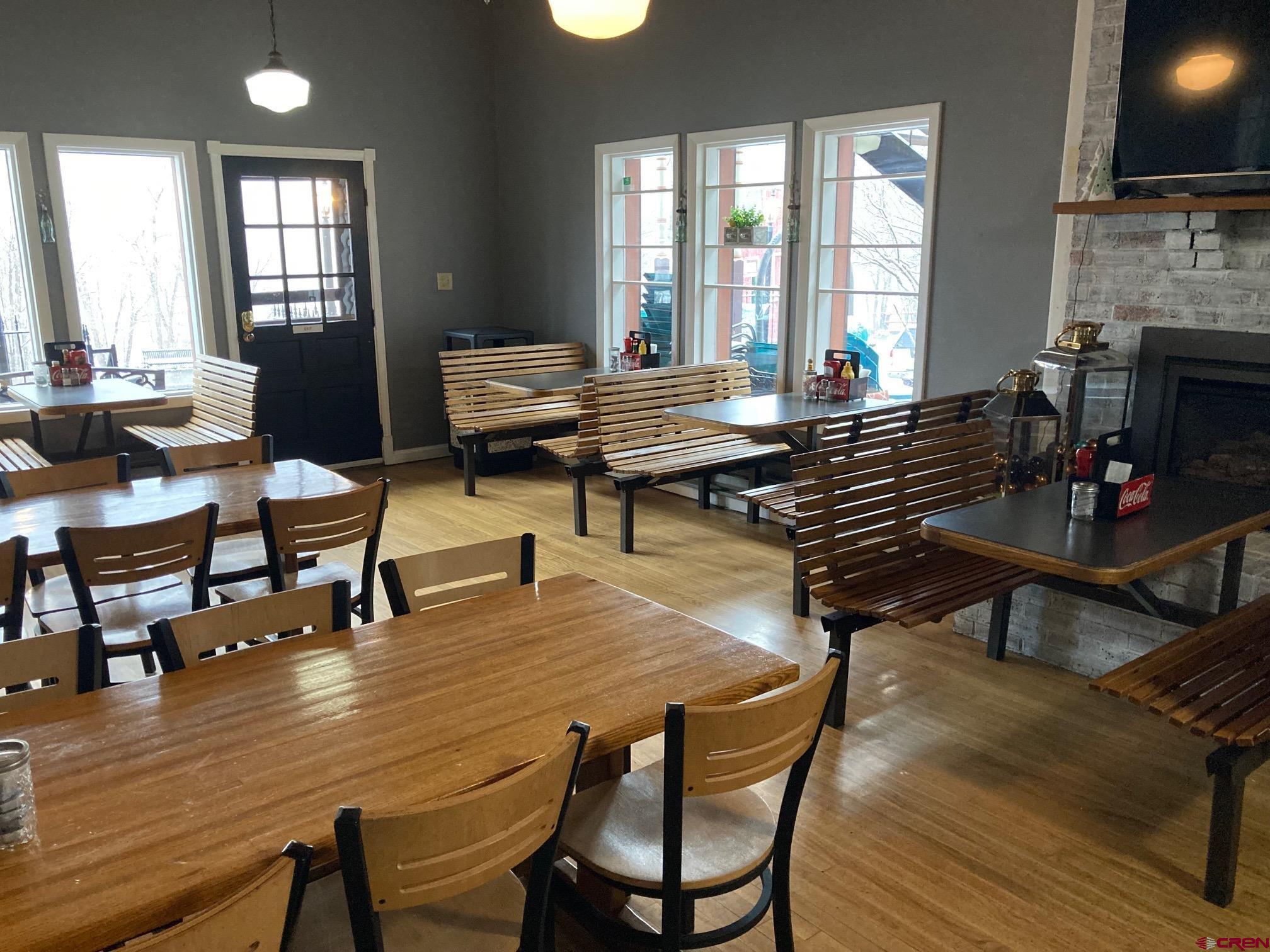 807 Main Street, Unit 3 Ouray, CO 81427 - Photo 15 of 22 a living room with furniture a fireplace and a flat screen tv