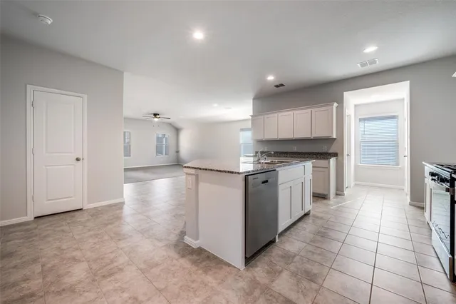a kitchen with stainless steel appliances a refrigerator sink and cabinets