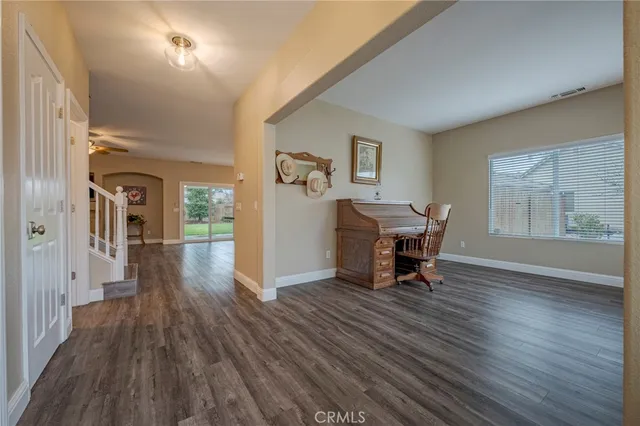 a kitchen with granite countertop white cabinets white stainless steel appliances and sink