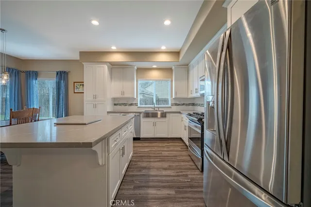 a bathroom with a double vanity sink toilet and shower