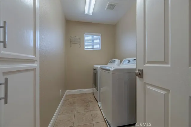 an empty room with closet and a chandelier fan