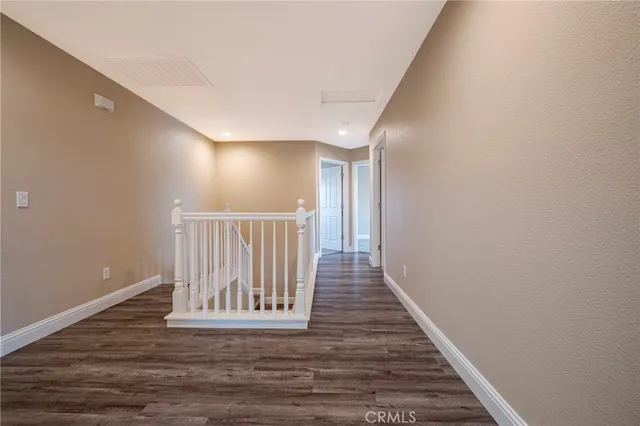 a view of a big house with a big yard and large trees