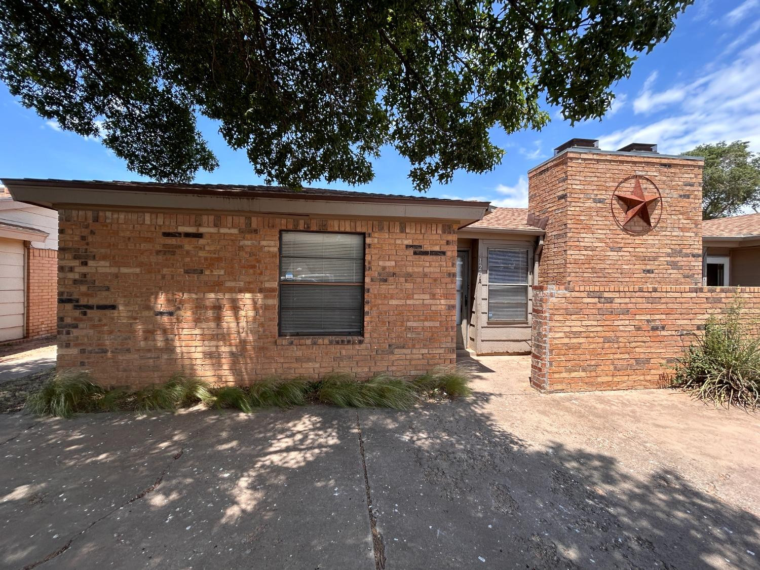 129 North Troy Avenue, Unit B Lubbock, TX 79416 - Photo 1 of 9 a front view of a house with a yard