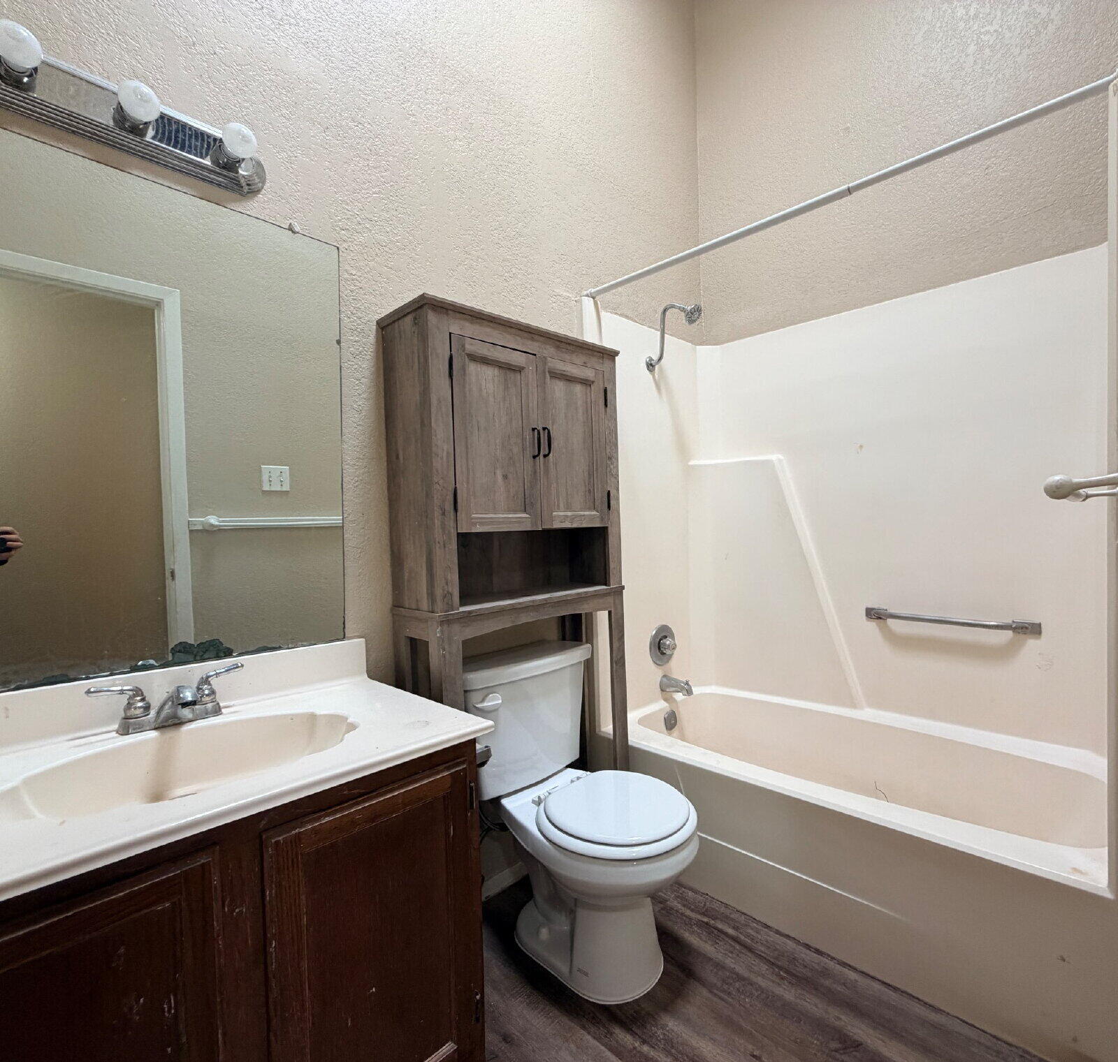 129 North Troy Avenue, Unit B Lubbock, TX 79416 - Photo 6 of 9 a bathroom with a sink a toilet and shower