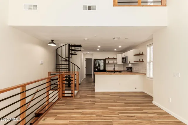a view of a living room and kitchen with furniture