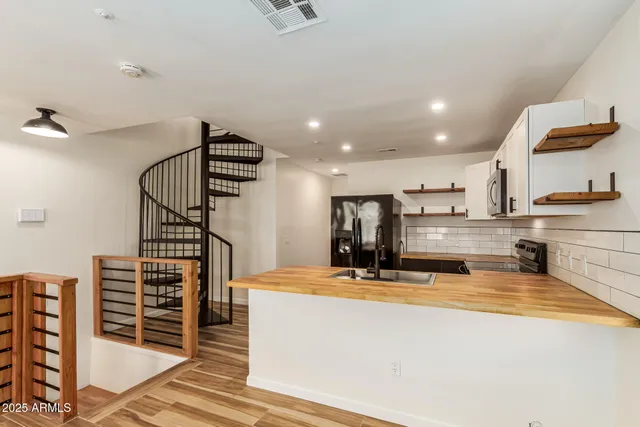 a view of kitchen with furniture and appliances