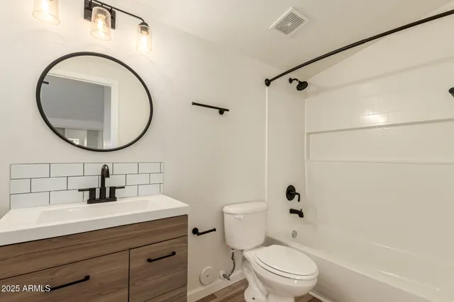 a bathroom with a sink a mirror a toilet and a shower