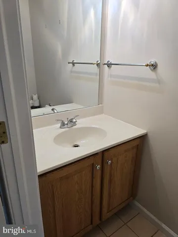 a bathroom with a sink vanity and a mirror