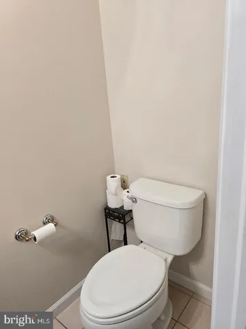 a white toilet sitting next to a shower