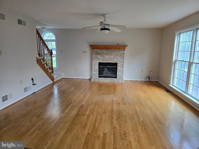 wooden floor in an empty room with a fireplace