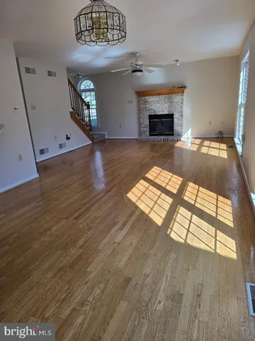 wooden floor with a fireplace in a room