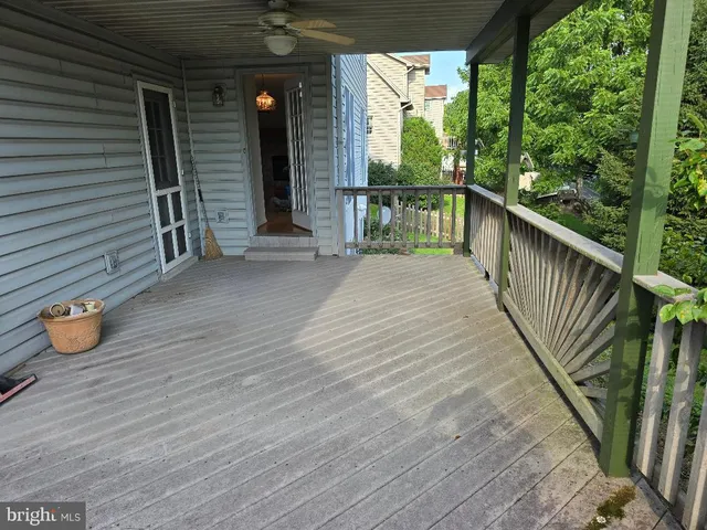 a view of a porch with wooden floor and fence