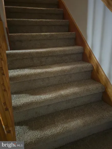 a close view of staircase with white walls