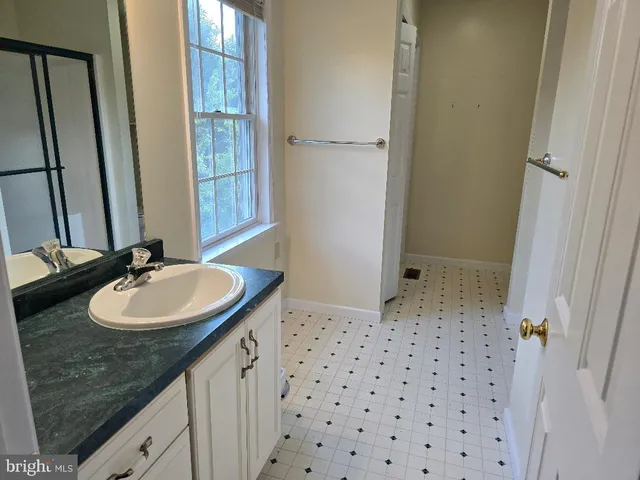 a bathroom with a glass shower door