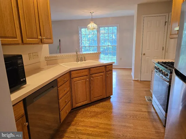 a kitchen with a sink a refrigerator and window