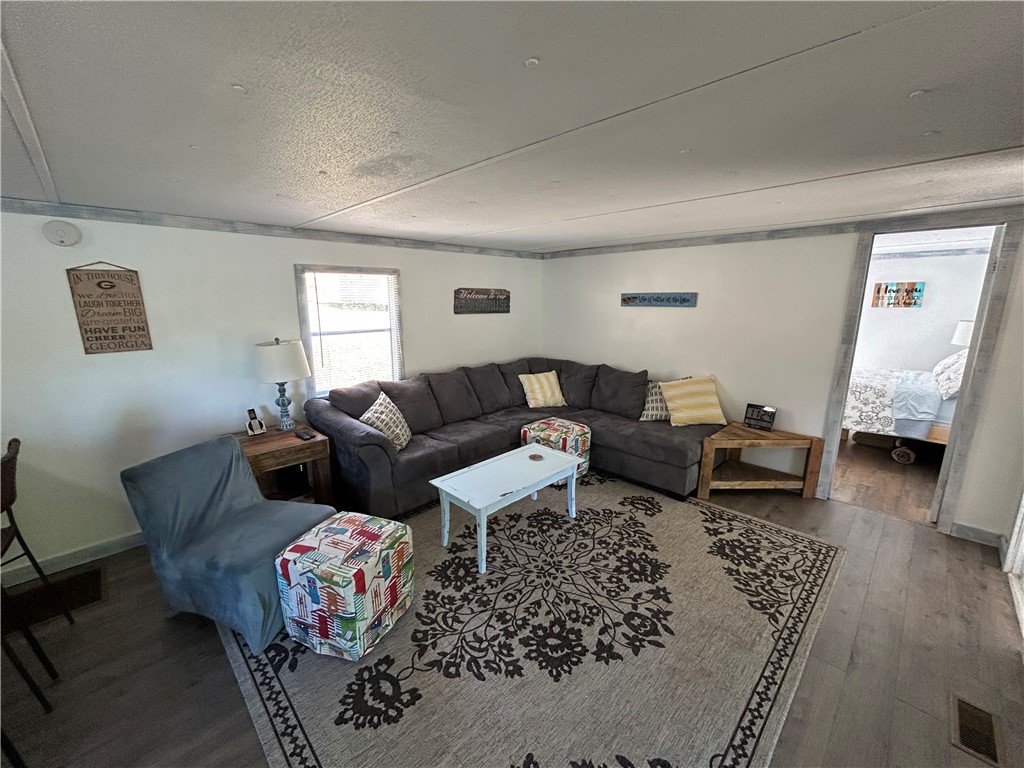 43 Sunset Cove Road Abbeville, SC 29620 - Photo 5 of 41 This living area boasts elegant flooring and an inviting ambiance, perfect for relaxation and gatherings.