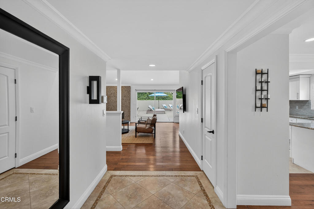 9325 La Shell Drive Tujunga, CA 91042 - Photo 7 of 46 a hallway with white cabinets and couches with wooden floor
