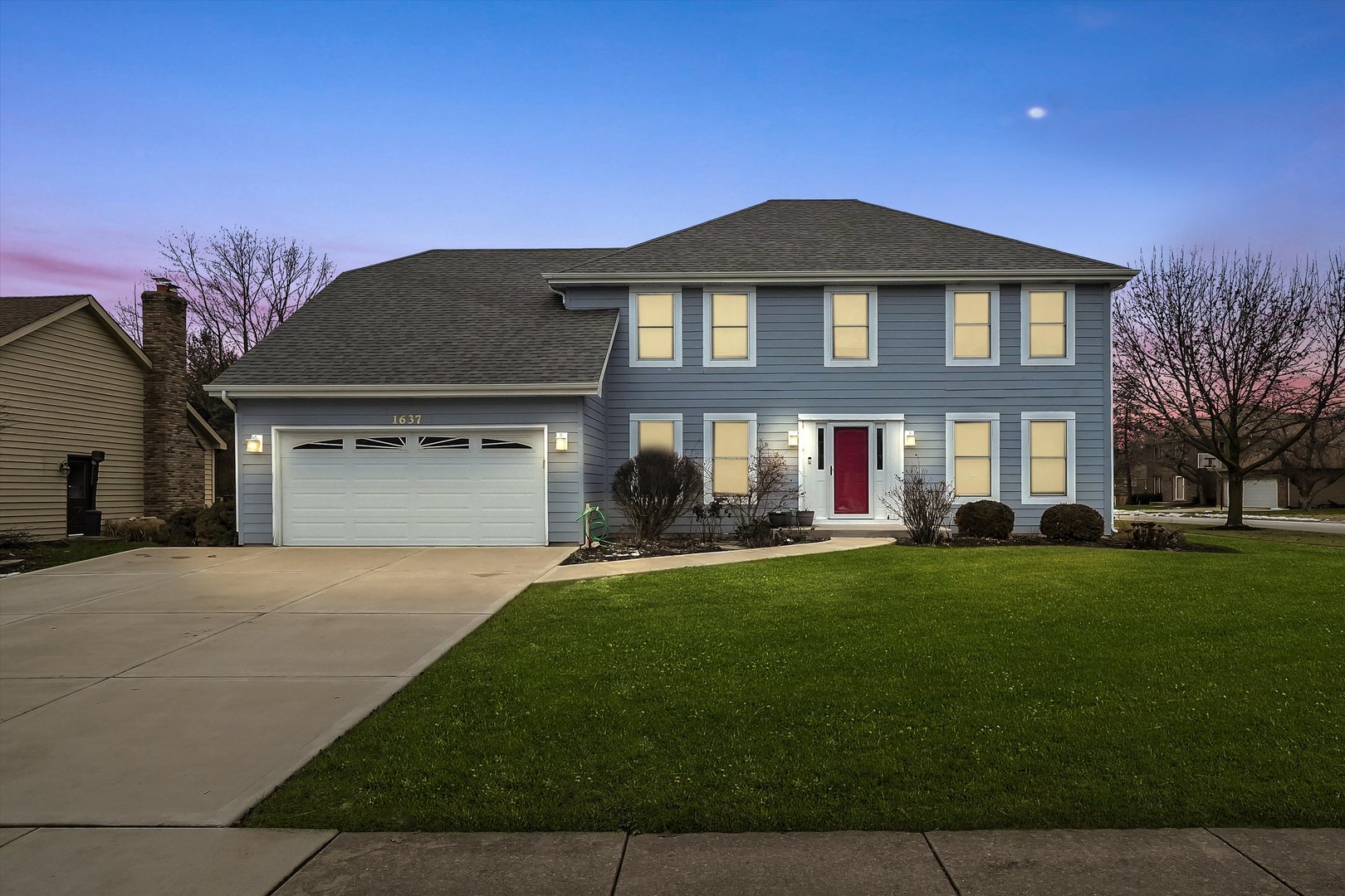 Undisclosed Address Naperville, IL 60563 - Photo 2 of 30 a front view of a house with a yard and garage