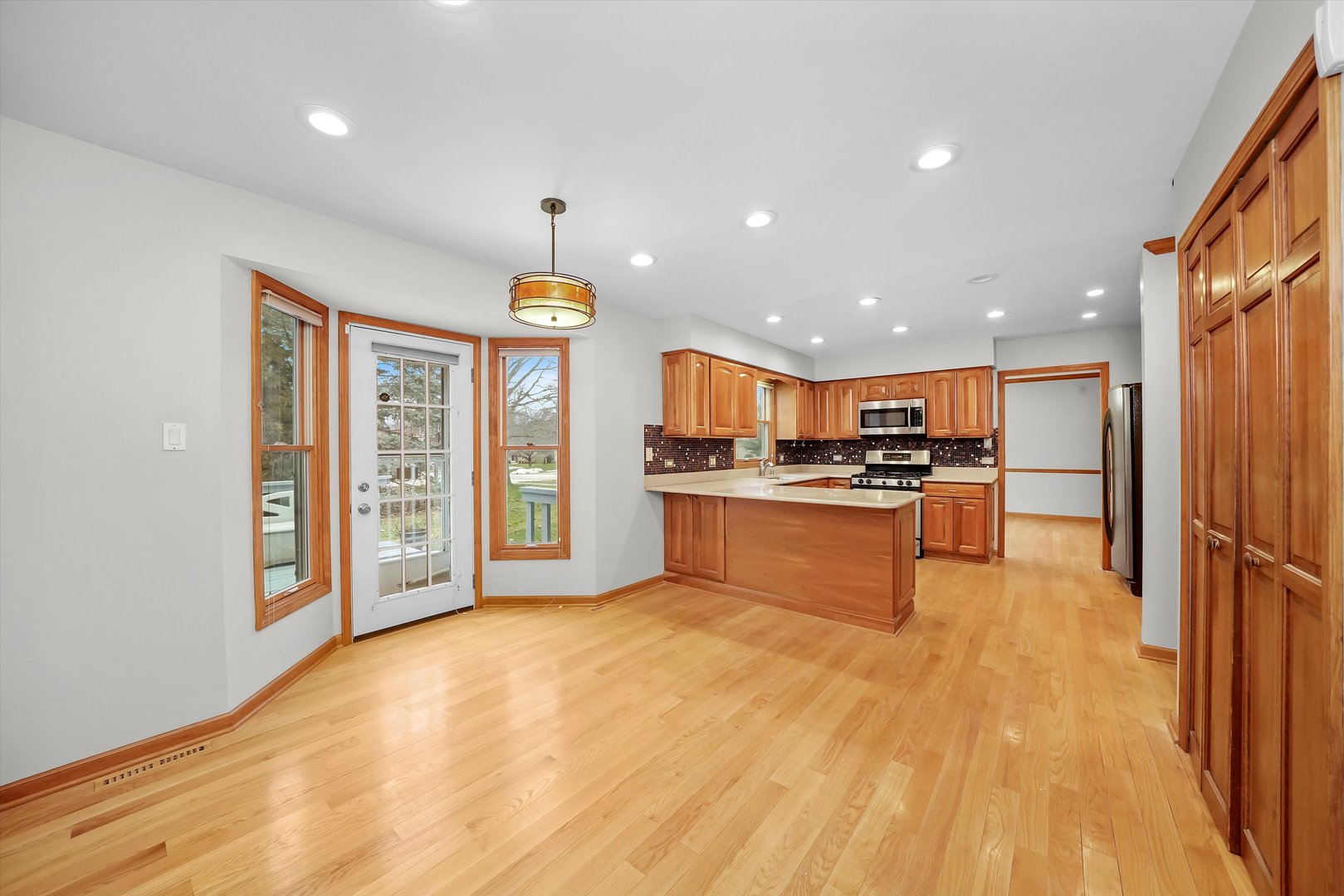 Undisclosed Address Naperville, IL 60563 - Photo 5 of 30 a kitchen with stainless steel appliances kitchen island granite countertop a refrigerator a stove a oven and a sink with granite countertops