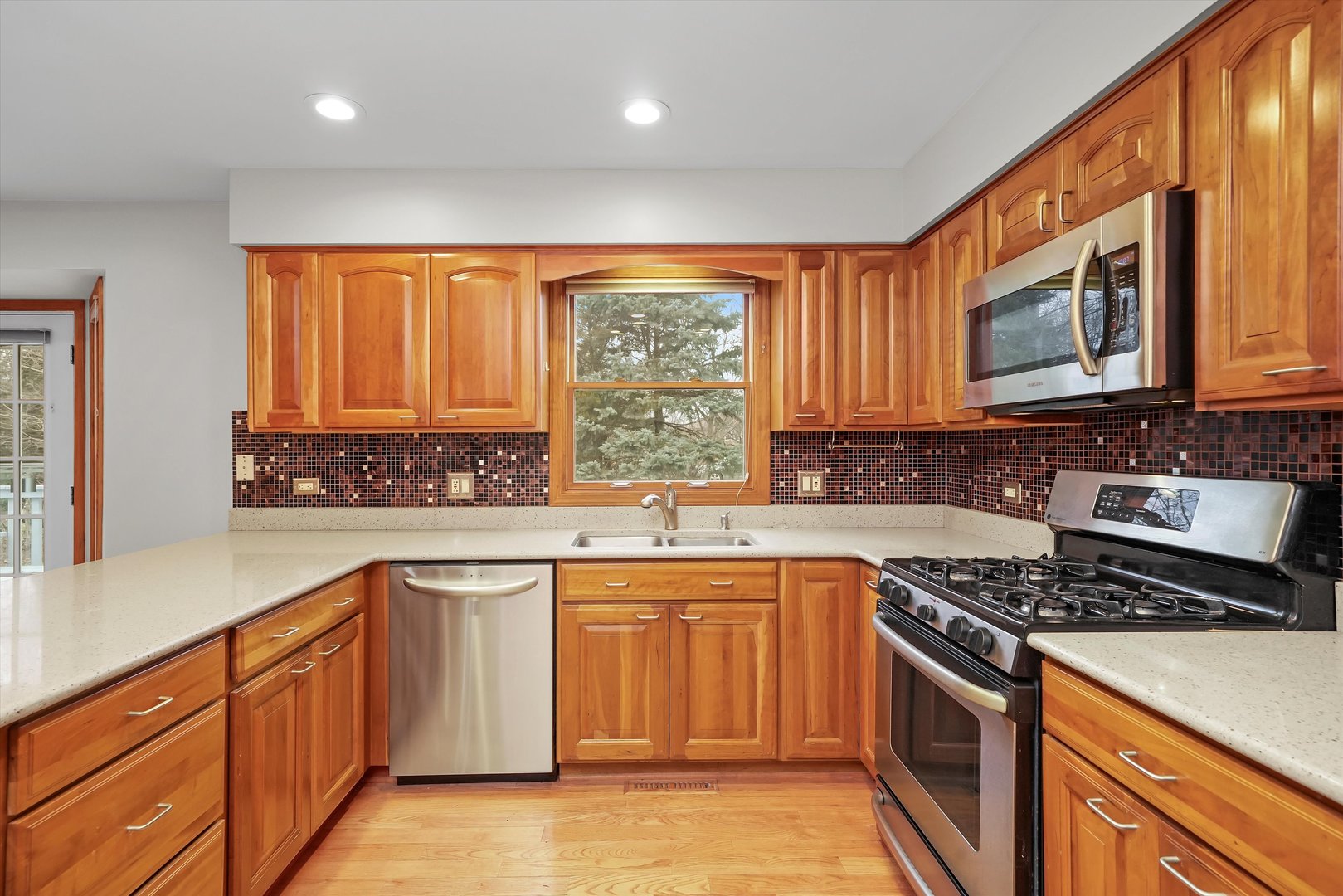 Undisclosed Address Naperville, IL 60563 - Photo 6 of 30 a kitchen with stainless steel appliances granite countertop a stove a sink dishwasher and a microwave oven with large cabinets