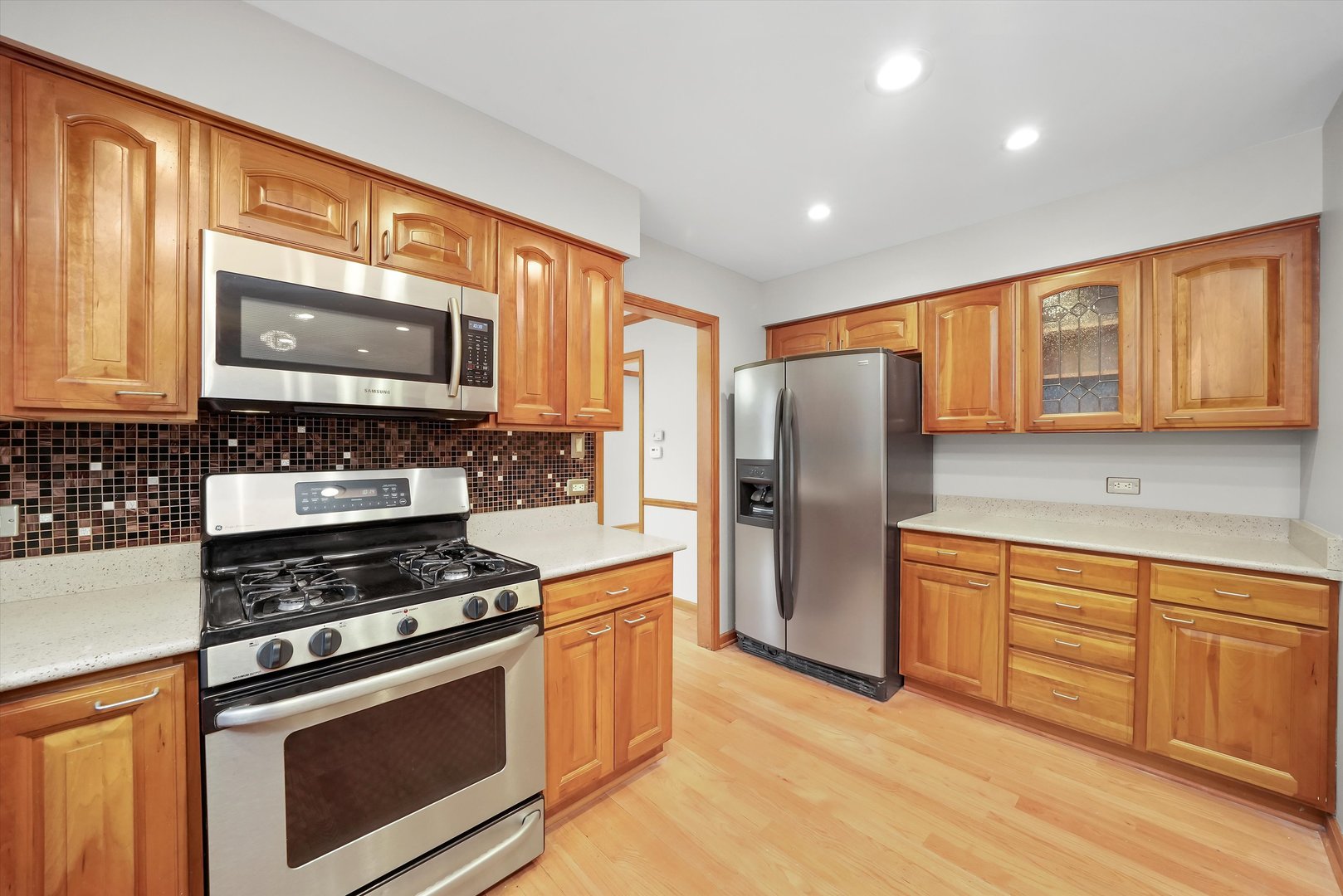 Undisclosed Address Naperville, IL 60563 - Photo 8 of 30 a kitchen with stainless steel appliances granite countertop a stove refrigerator and microwave