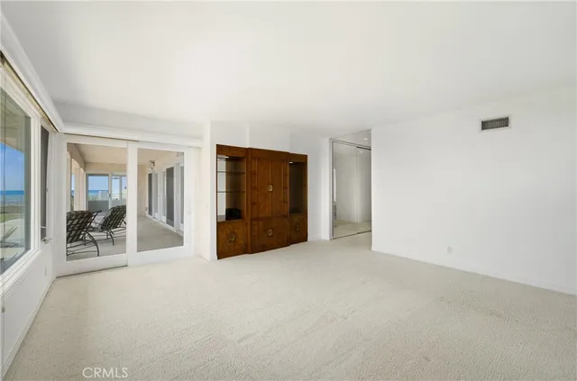 an empty room with furniture and natural light