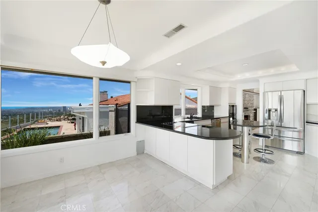 a large white kitchen with a large counter top furniture and kitchen view