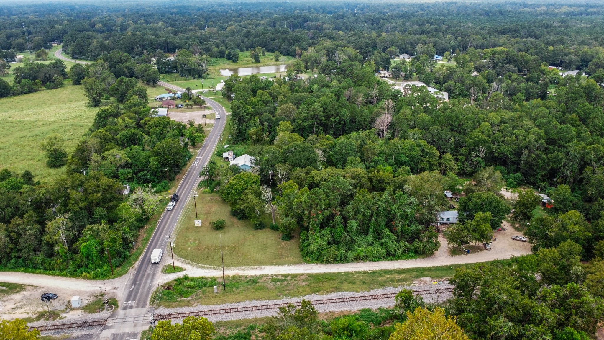 328 West Fm Goodrich, TX 77335 - Photo 1 of 8 an aerial view of residential houses with outdoor space and trees