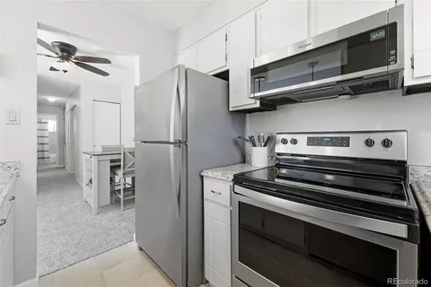 a bedroom with a bed and a flat tv screen on dresser