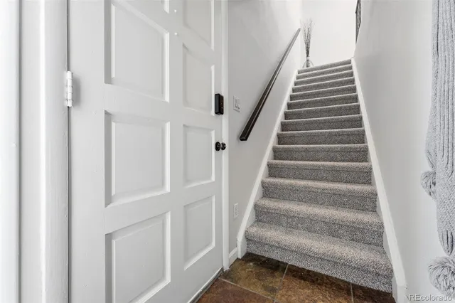 a view of staircase with white walls and a window