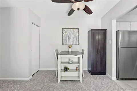 a kitchen with a sink dishwasher and white cabinets with wooden floor