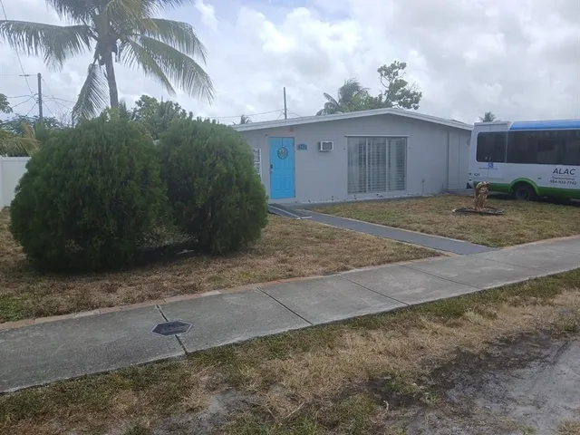 a view of a house with a yard and a garage