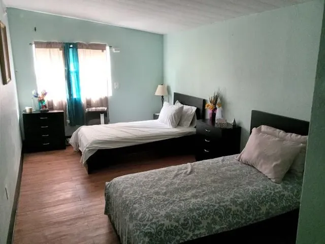 a bedroom with a bed and window