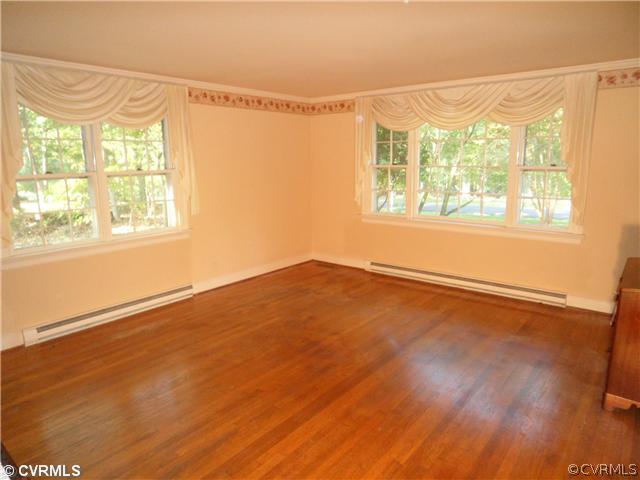 2651 Radstock Road Midlothian, VA 23113 - Photo 2 of 12 a view of an empty room with a window and wooden floor