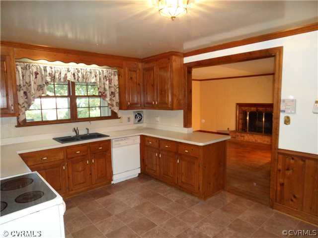 2651 Radstock Road Midlothian, VA 23113 - Photo 4 of 12 a kitchen with stainless steel appliances granite countertop a sink a stove and a refrigerator