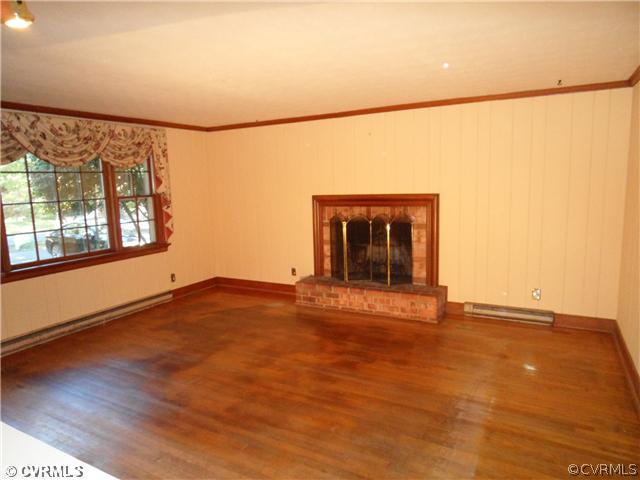 2651 Radstock Road Midlothian, VA 23113 - Photo 5 of 12 an empty room with wooden floor and windows