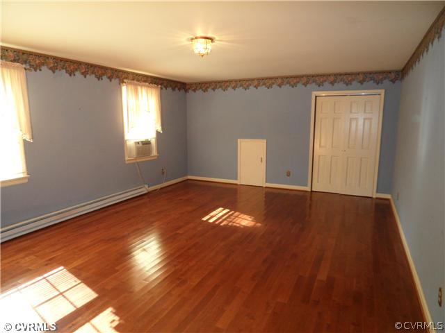 2651 Radstock Road Midlothian, VA 23113 - Photo 6 of 12 a view of empty room with wooden floor and fan