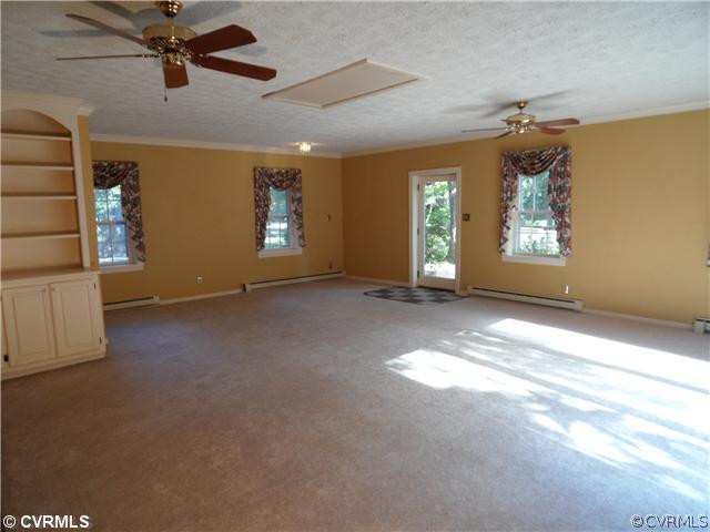 2651 Radstock Road Midlothian, VA 23113 - Photo 7 of 12 a view of a livingroom with a ceiling fan and window