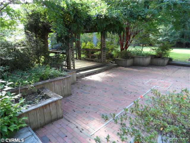 2651 Radstock Road Midlothian, VA 23113 - Photo 9 of 12 a view of a backyard with large trees and plants