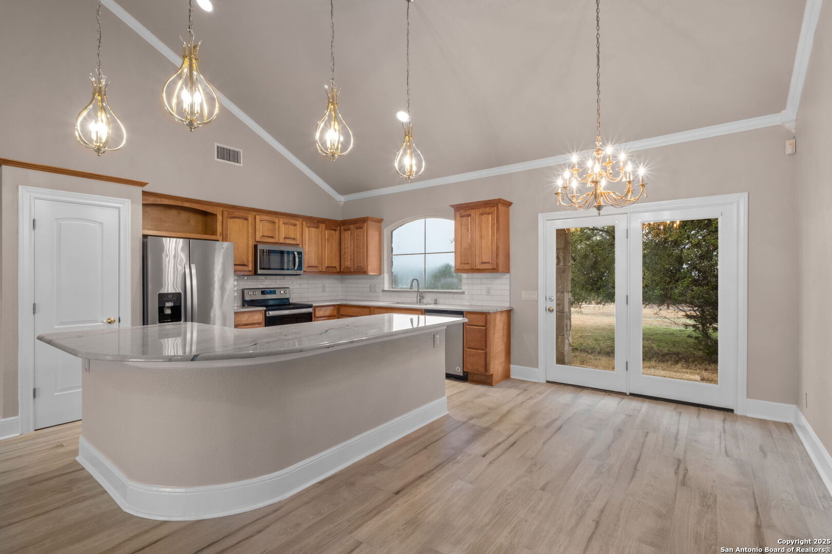 1069 Fawn River Drive Spring Branch, TX 78070 - Photo 19 of 25 a large white kitchen with a large island oven a stove and refrigerator