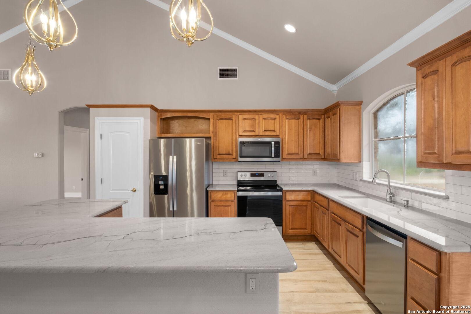 1069 Fawn River Drive Spring Branch, TX 78070 - Photo 20 of 25 a large kitchen with stainless steel appliances granite countertop a sink refrigerator stove and microwave