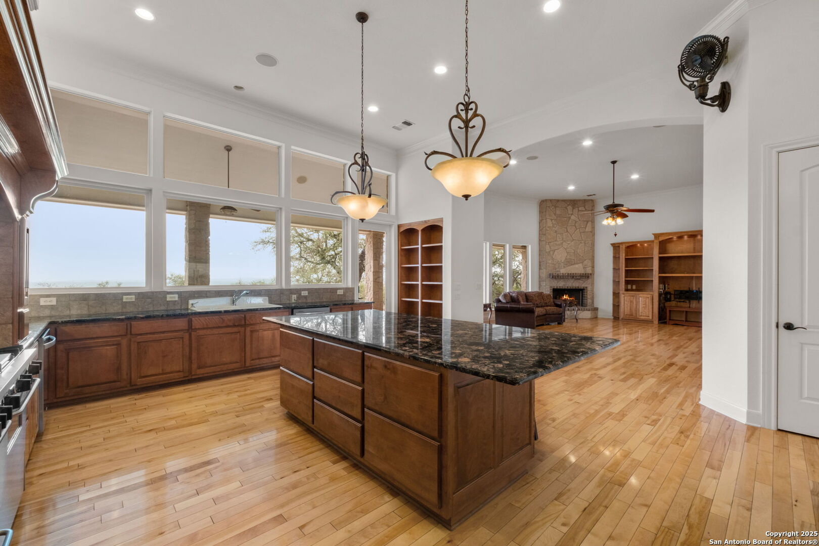 1069 Fawn River Drive Spring Branch, TX 78070 - Photo 10 of 25 a large kitchen with a large island oven a stove a sink a center island a refrigerator and a view of living room