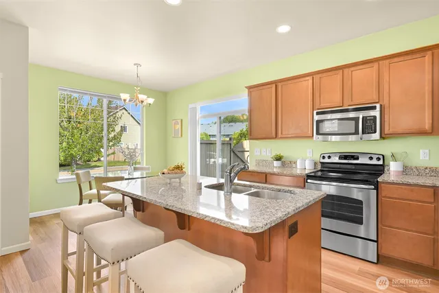 a kitchen with a stove a sink and a refrigerator