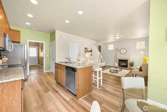 a large white kitchen with wooden floor