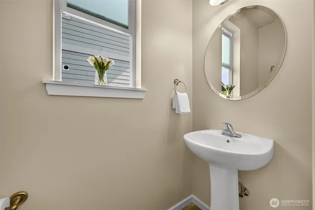 a bathroom with a sink a mirror and a window